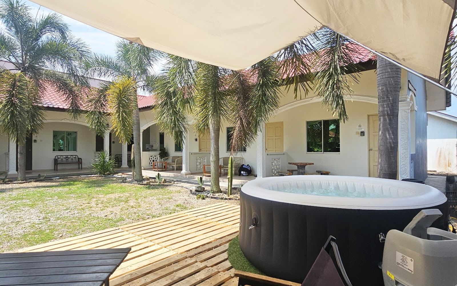 Courtyard and rooms at CASA YUSIKA with hot tub deck and palms
